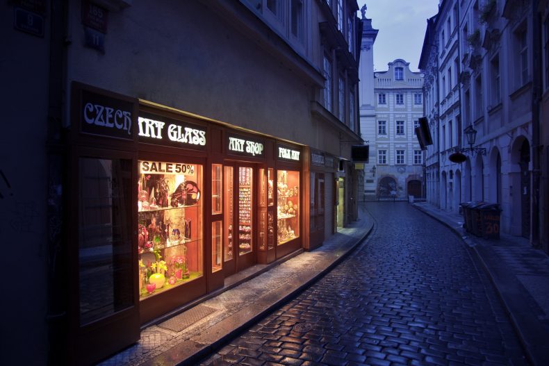 Illuminated souvenir shop in an old narrow street, Prague